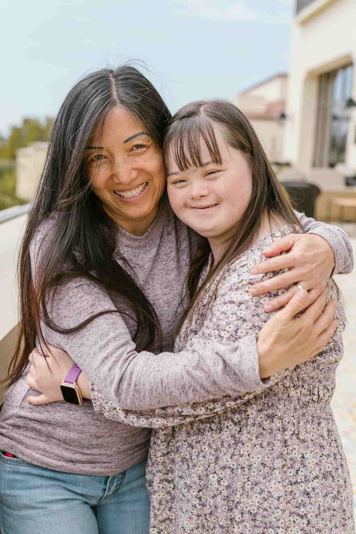 Mother and daughter with special needs embracing - Godaelli Home Care